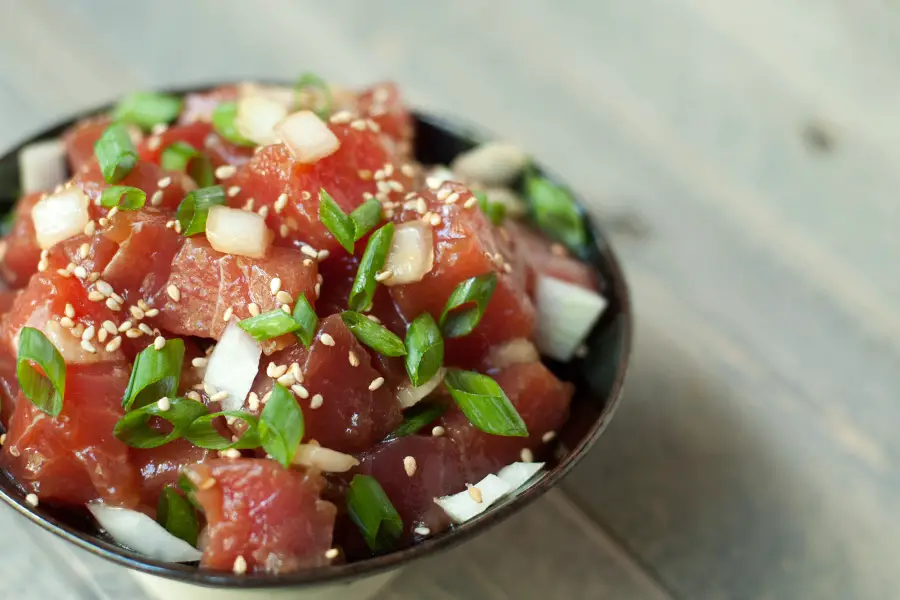 Side view close up of a bowl of ahi poke.