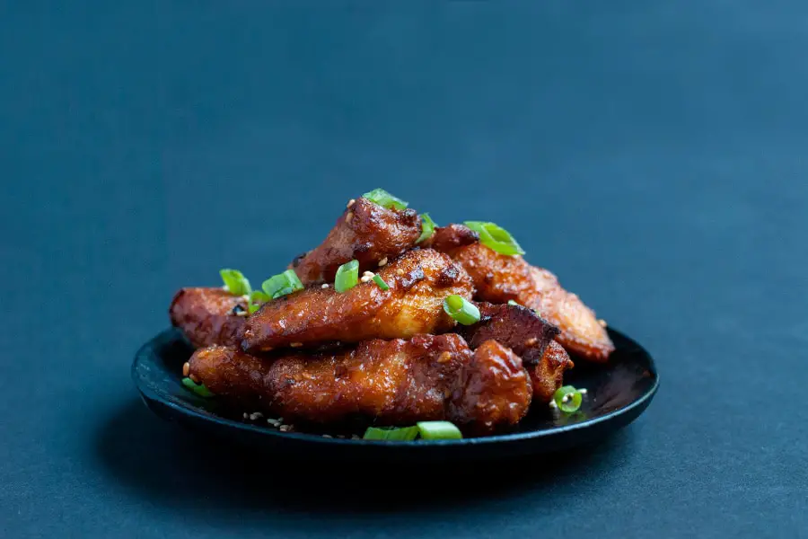 Fried mochiko chicken marinated in a mochiko sweet rice flour sauce and topped with green onions.