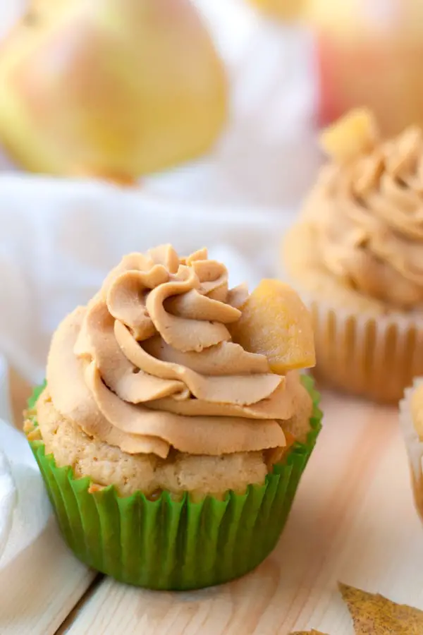 Caramel whipped cream frosting on top of a cupcake.