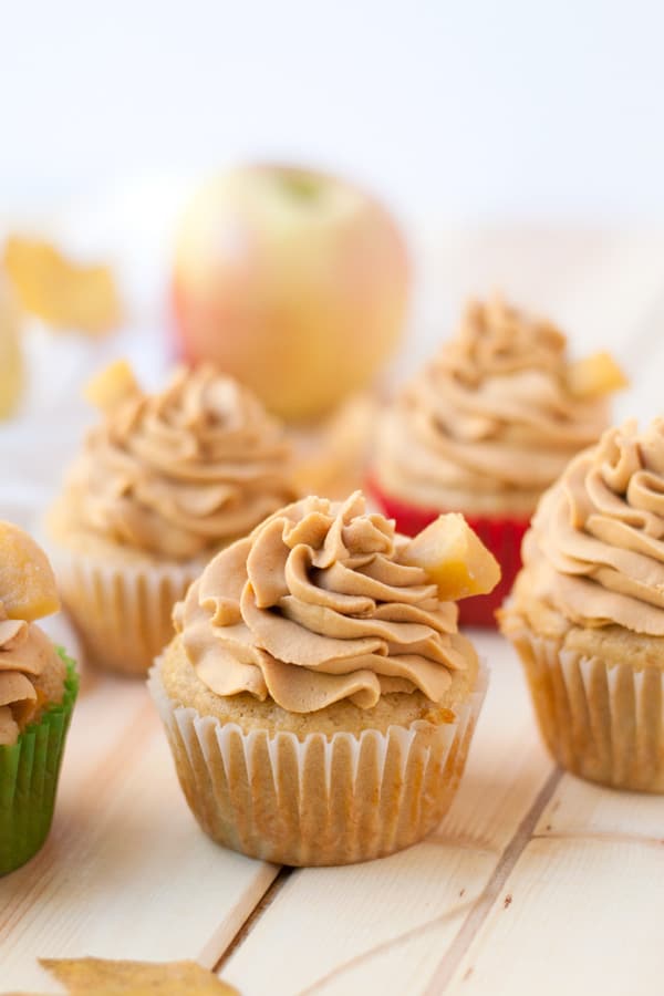 Caramel apple cupcakes with caramel whipped cream frosting.