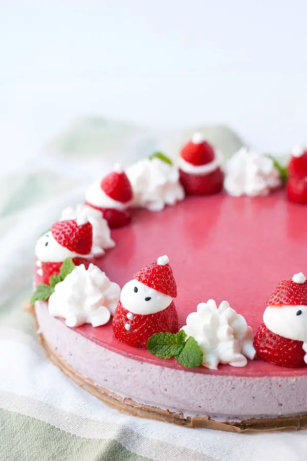 A spongey cake with strawberry mousse filling and santa strawberries