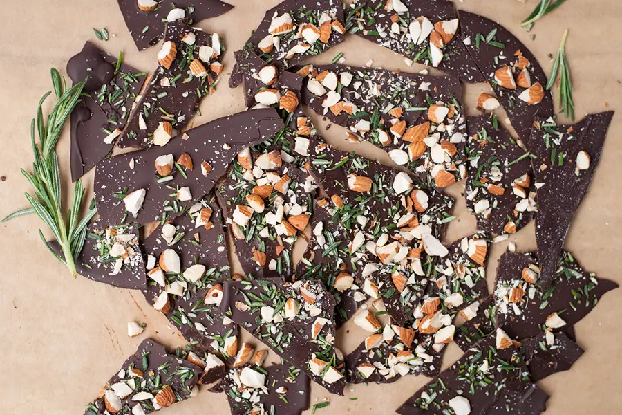 Rosemary Bark- This ultra thin dark chocolate rosemary bark is loaded with sea salt, roasted almond pieces, and chopped fresh rosemary.