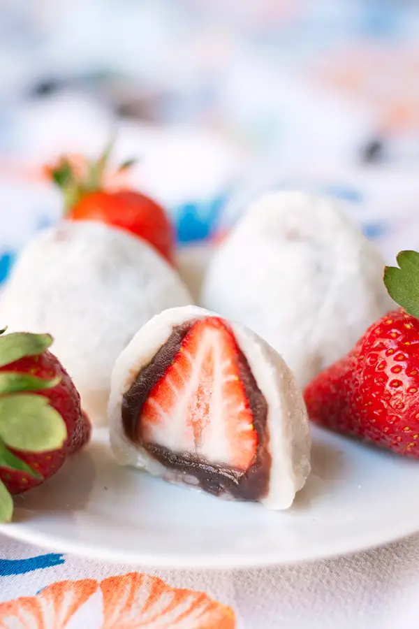 Strawbery Mochi (Daifuku)- a delicious Japanese mochi dessert. A whole strawberry is covered in a layer of red bean paste and wrapped in mochi.