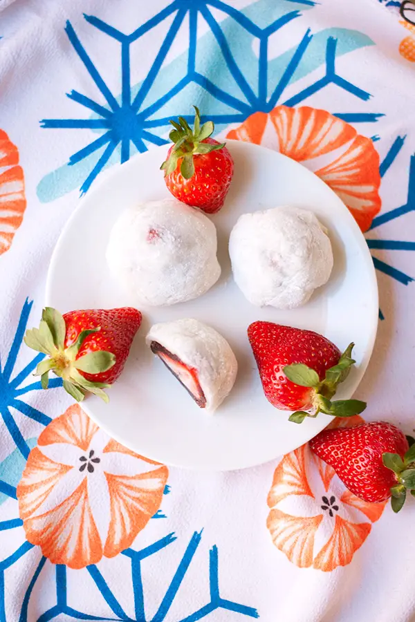 Strawbery Mochi (Daifuku)- a delicious Japanese mochi dessert. A whole strawberry is covered in a layer of red bean paste and wrapped in mochi.