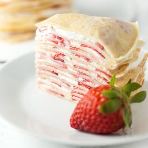 Strawberry Crepe Cake-Filled with whipped cream and strawberries, this fancy looking strawberry crepe cake comes together easily to make an impressive and delicious dessert.