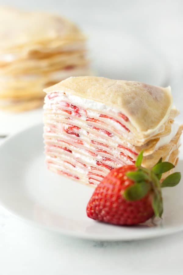 Strawberry Crepe Cake-Filled with whipped cream and strawberries, this fancy looking strawberry crepe cake comes together easily to make an impressive and delicious dessert.