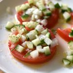 Sliced Tomato Salad with Cucumber Onion Marinade- Sliced tomatoes topped with a chopped cucumbers and onion in a tangy marinade. This sliced tomato salad is so fresh and comes together in a snap.