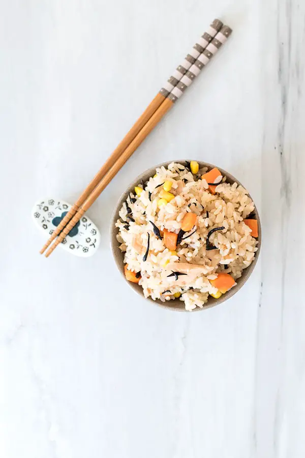 Top view of tuna takikomi rice with chopsticks. 