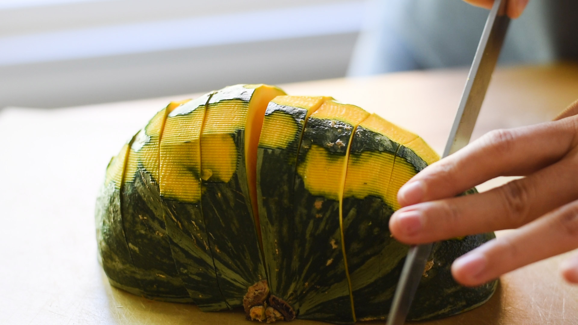 Cutting peeled kabocha squash (Japanese pumpkin) for a squash soup recipe.