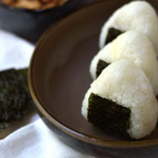 Tuna mayo onigiri, or rice ball, is a simple and delicious Japanese snack. Rice is filled with a flavorful tuna and mayonnaise, shaped, and wrapped with a sheet of nori (seaweed). 
