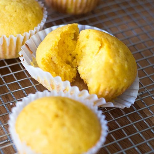 Kabocha squash muffin torn open to see fluffy inside.