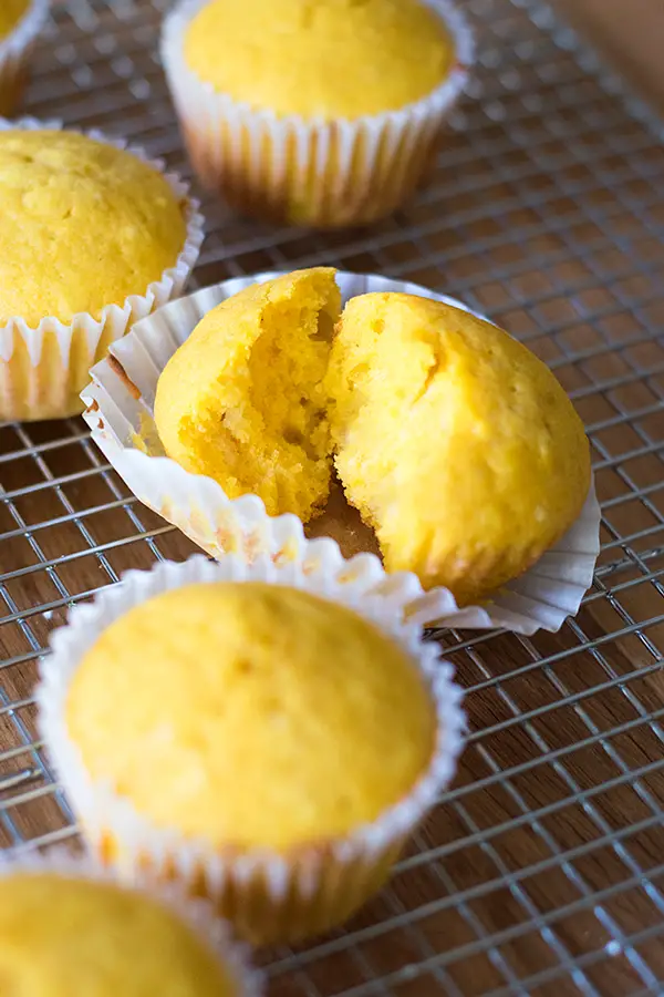 Kabocha squash muffin torn open to see fluffy inside.