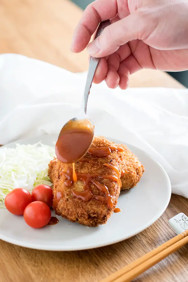 Tonkatsu sauce over a plate of korokke (Japanese croquettes). This can also be used as a chicken katsu sauce recipe.