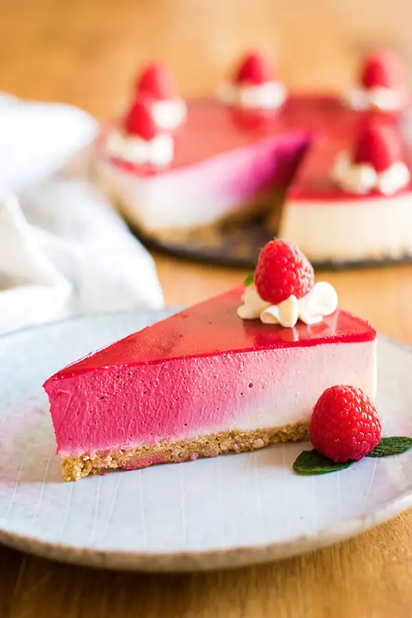 Pink ombre cheesecake made with freeze dried raspberries with whipped cream topping