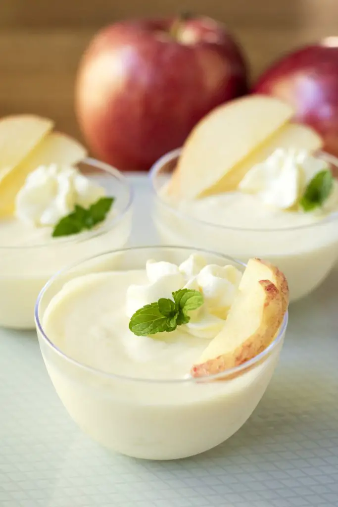 This fresh apple mousse is light, crisp, and refreshing. The chunks of apple add a nice texture, and the lack of spices lets the apple flavor really shine. Apple mousse topped with whipped cream, mint, and thinly sliced apples
